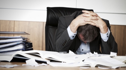 Frustrated business person overloaded with work.