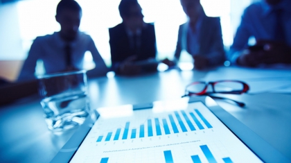 Business document with charts on background of working business team