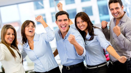 Successful business group with arms up at the office