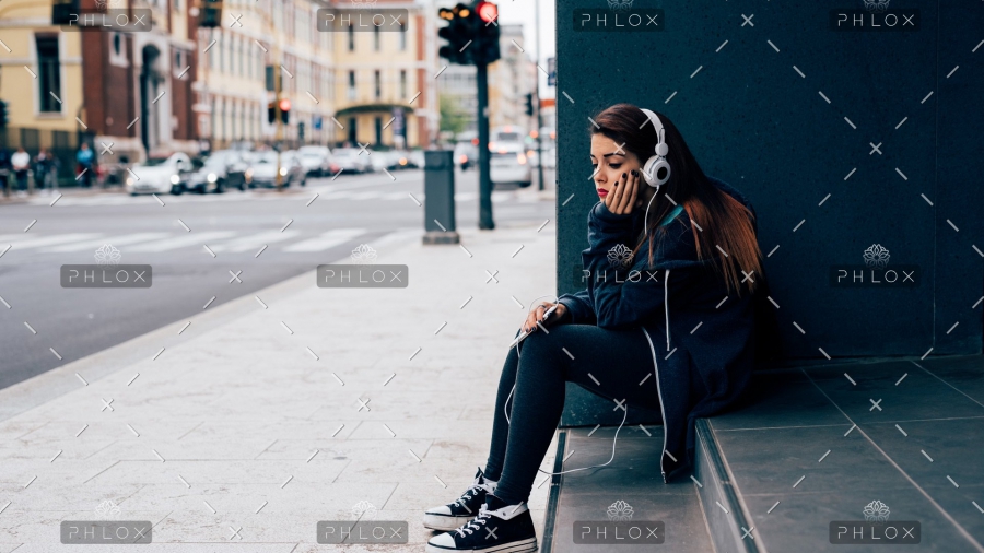 demo-attachment-19-young-woman-sitting-on-a-step-PE6MPZ9